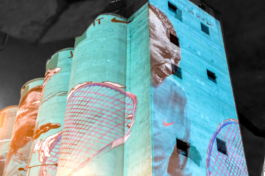 Nike brand projected onto silo